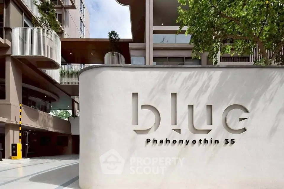 Modern building entrance with sleek architectural design at Blue Phahonyothin 35.