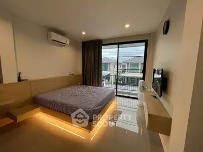 Modern bedroom with large window and sleek design in a contemporary home.