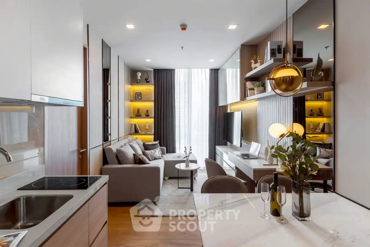 Modern living room with open kitchen, stylish decor, and natural light