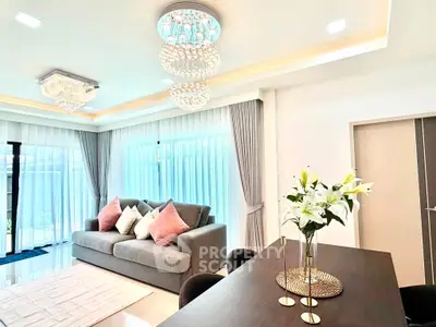 Luxurious living room with elegant chandeliers and modern decor, perfect for stylish living.