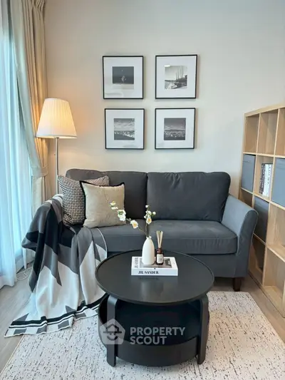 Cozy living room with stylish decor, featuring a modern sofa, elegant lamp, and chic wall art.