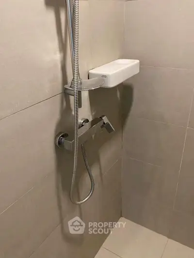 Modern bathroom shower with sleek fixtures and neutral tiles