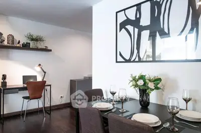 Stylish dining area with modern decor and workspace in a contemporary apartment.