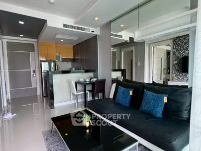 Modern open-layout living room with sleek kitchen and stylish decor