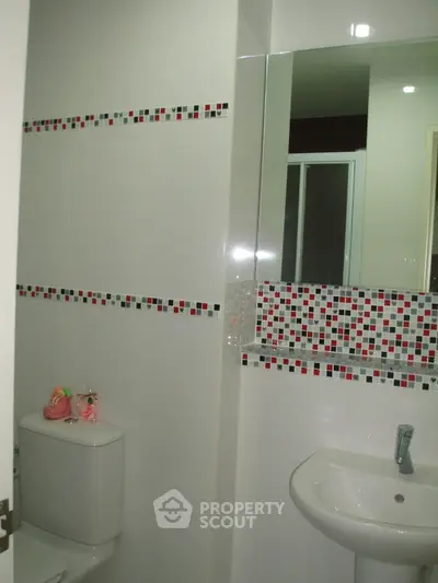 Modern bathroom with stylish mosaic tile accents and sleek fixtures.