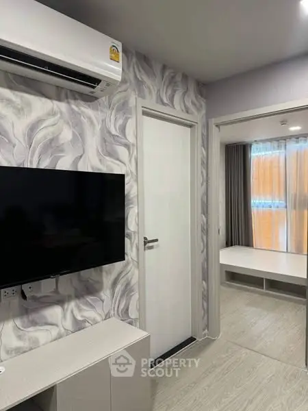Modern apartment interior with stylish wallpaper and sleek TV setup