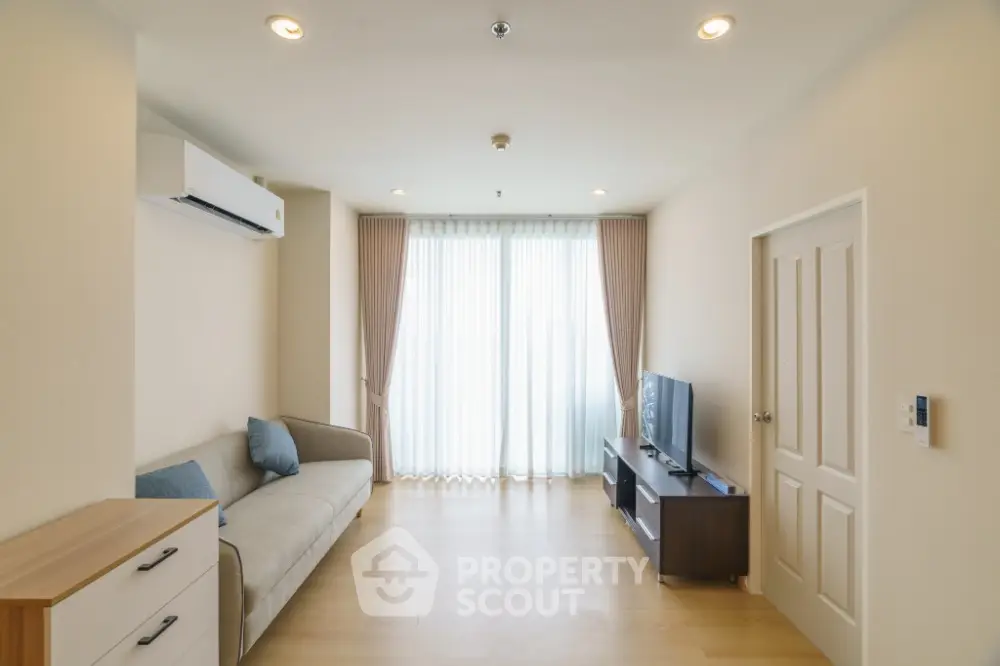 Spacious modern living room with natural light and minimalist decor.