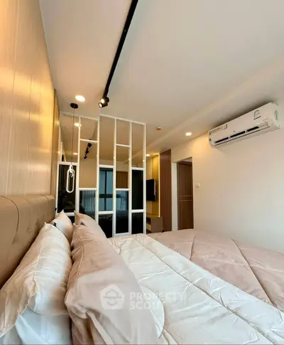 Modern bedroom with stylish decor and air conditioning in a contemporary apartment.