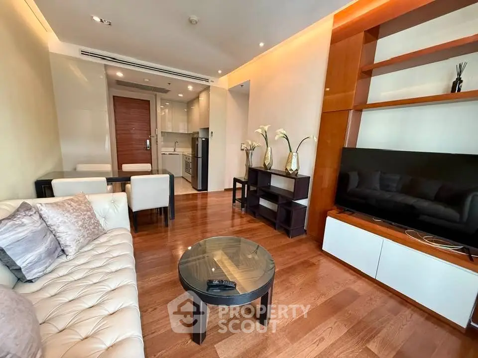 Modern living room with elegant decor and open kitchen layout in a stylish apartment.
