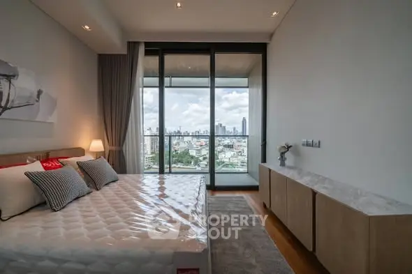 Luxurious bedroom with city view and spacious balcony access.