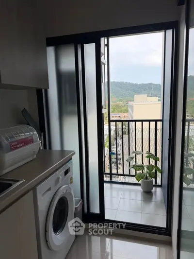 Modern apartment balcony with washing machine and scenic view