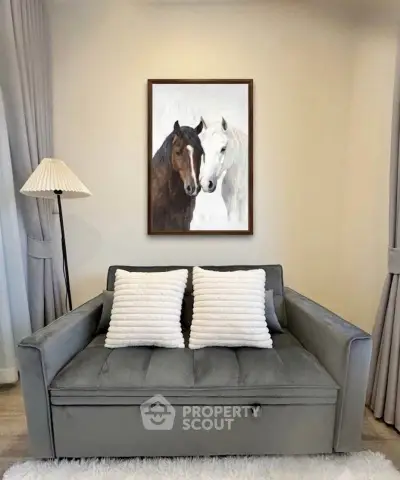 Stylish living room with elegant gray sofa and horse painting, perfect for modern interiors.