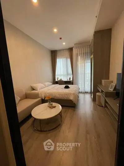 Modern bedroom with cozy decor and natural light, featuring a comfortable bed and stylish furniture.
