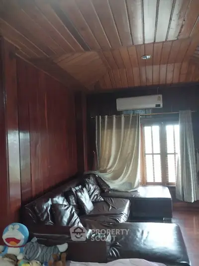 Cozy wooden living room with leather sofa and air conditioning