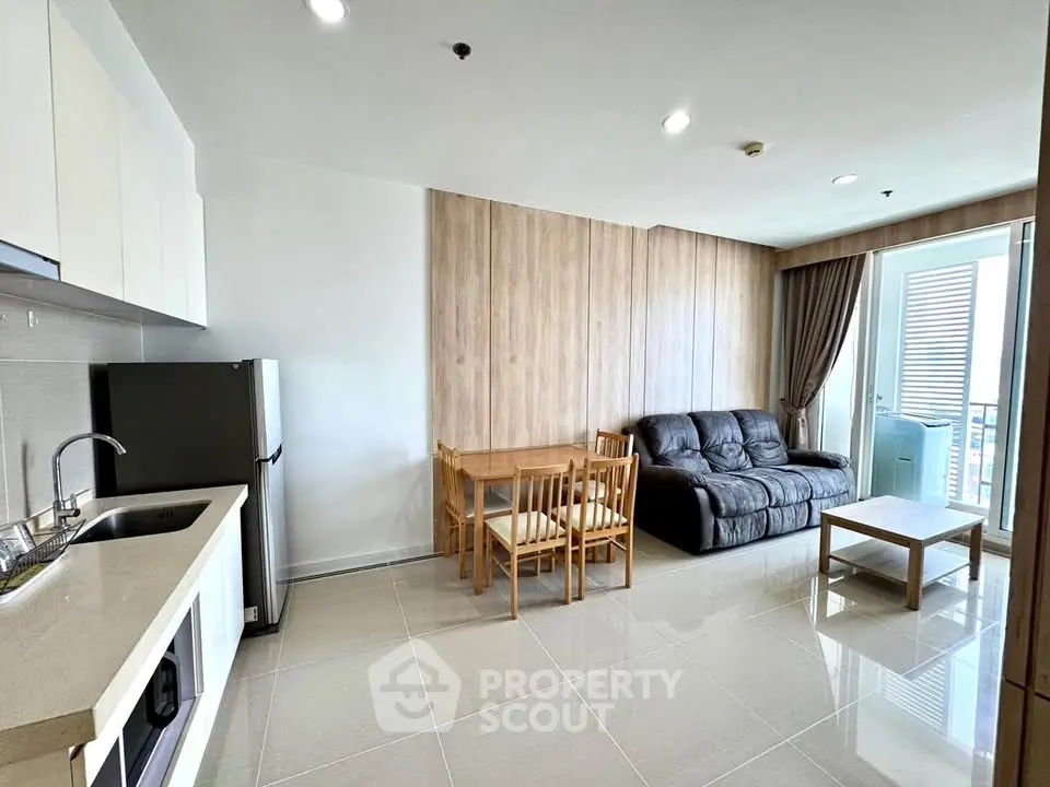 Modern living room with sleek kitchen and cozy seating area