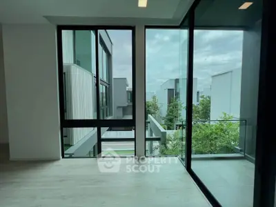 Modern corner unit with floor-to-ceiling windows and stunning view of contemporary architecture.