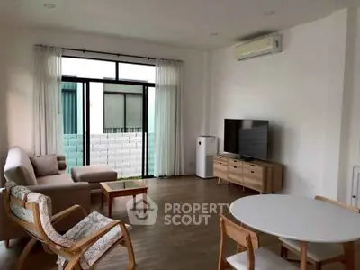 Modern living room with stylish furniture and large windows for natural light.