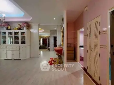 Spacious interior with elegant decor and ample natural light, featuring a stylish cabinet and cozy living area.