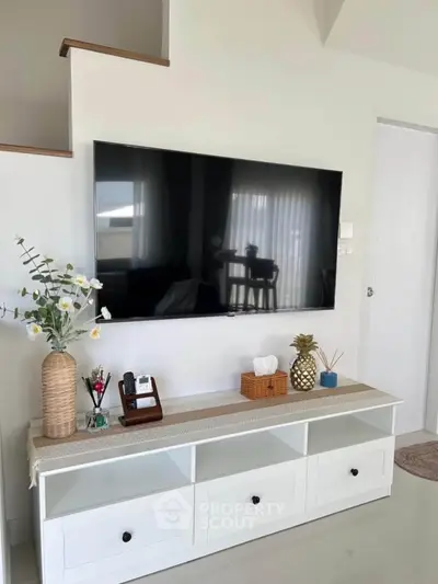 Modern living room with wall-mounted TV and stylish decor