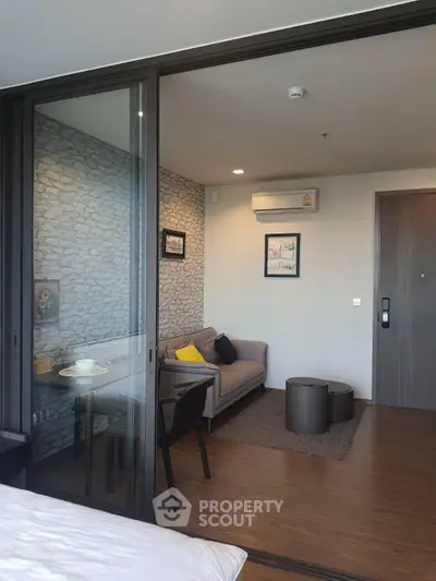 Modern living room with stylish decor and sliding glass doors in a contemporary apartment.