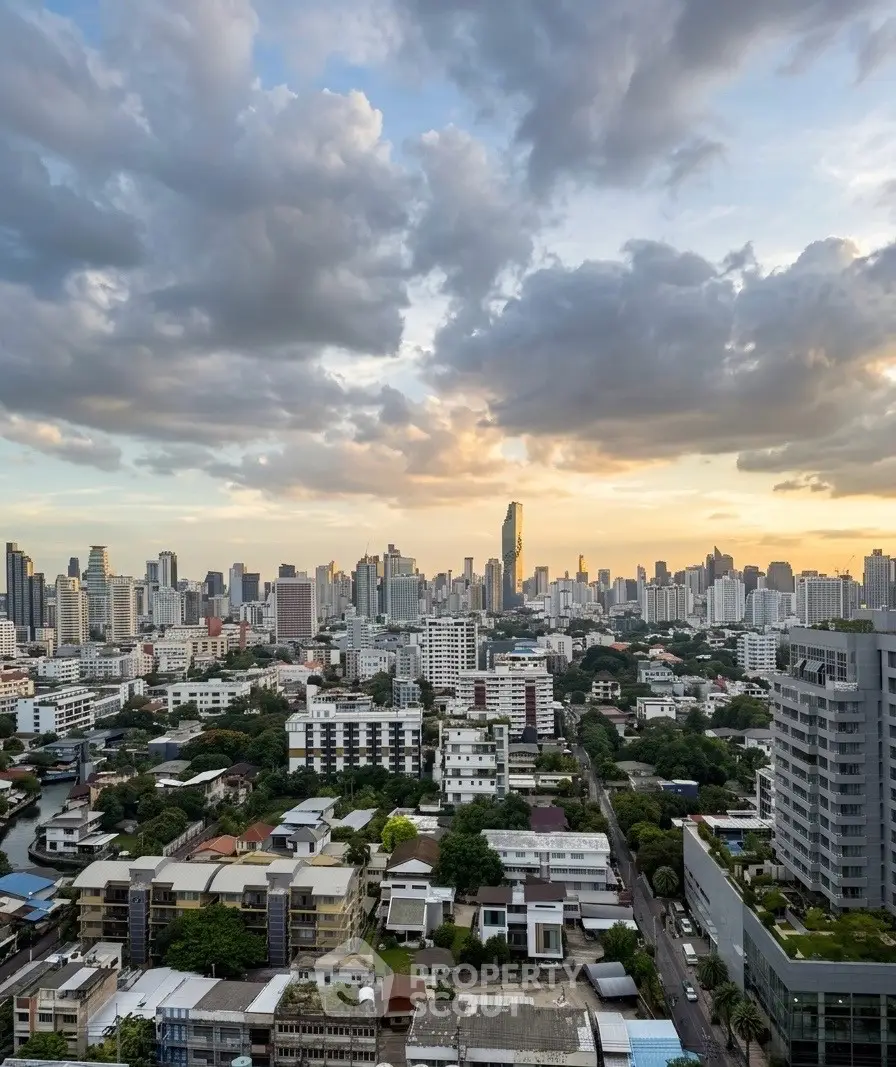 Stunning cityscape view from a high-rise building at sunset, showcasing urban skyline and vibrant clouds.