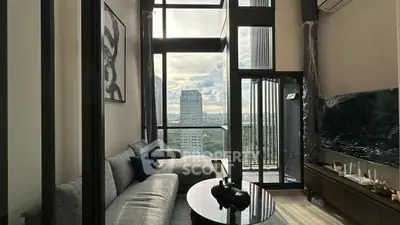 Modern living room with floor-to-ceiling windows and stunning city view