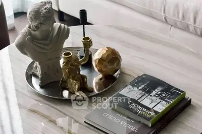 Elegant living room coffee table with decorative sculpture and books