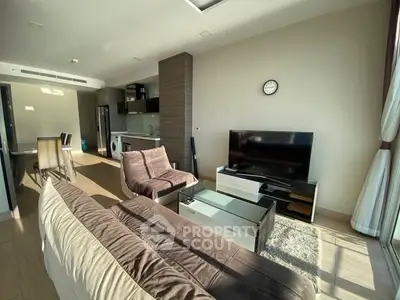 Spacious modern living room with natural light and stylish furnishings