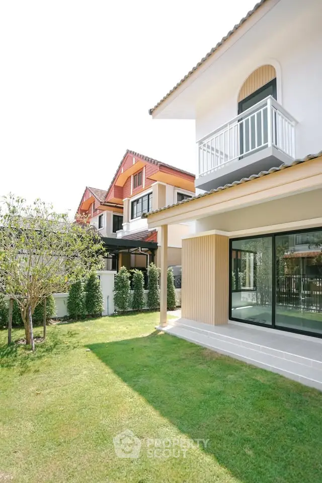 Charming suburban home with lush green lawn and modern architecture, perfect for family living.