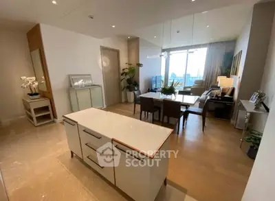 Spacious open-plan living and dining area with modern decor and large windows.