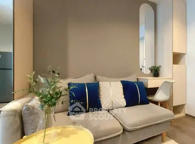Modern living room with stylish sofa and elegant decor in a cozy apartment setting.