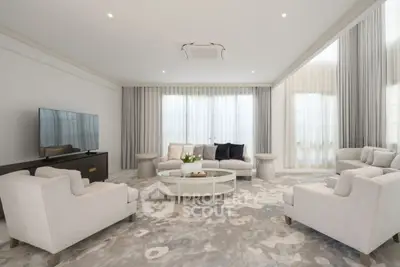 Luxurious modern living room with elegant furniture and large windows, perfect for relaxation and entertainment.