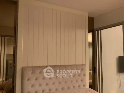 Modern bedroom with tufted headboard and sliding glass doors