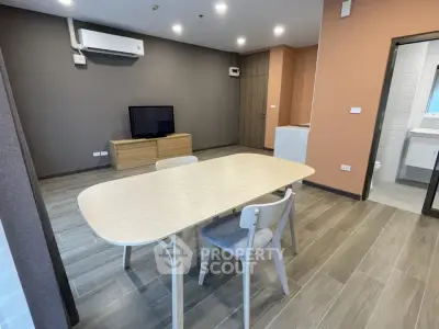 Modern open-plan living room with dining area and sleek furniture
