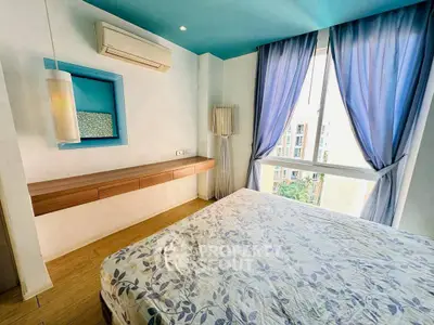 Bright bedroom with large window and modern decor in urban apartment