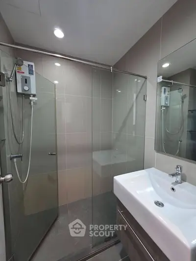 Modern bathroom with glass shower enclosure and sleek sink design