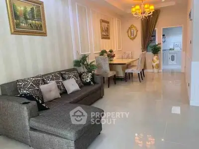 Elegant living room with stylish decor and open layout leading to dining area, perfect for modern living.