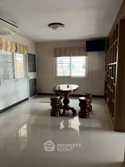 Spacious living room with elegant wooden furniture and natural light