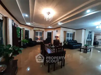 Spacious living room with elegant chandelier and modern furniture