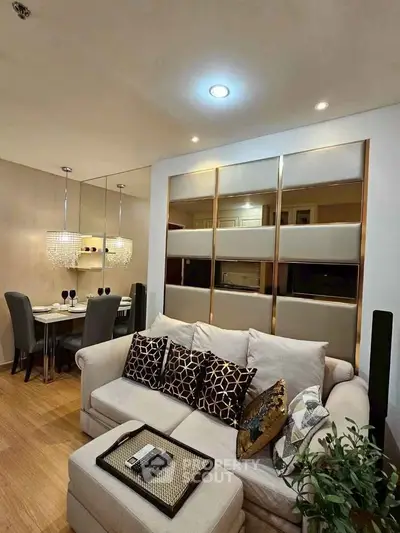 Elegant living room with modern decor and cozy dining area, perfect for stylish urban living.
