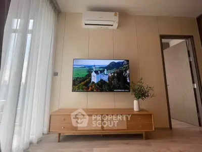 Modern living room with wall-mounted TV and air conditioner, featuring stylish wooden console and elegant decor.