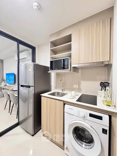 Modern kitchen with sleek appliances and open layout in stylish apartment