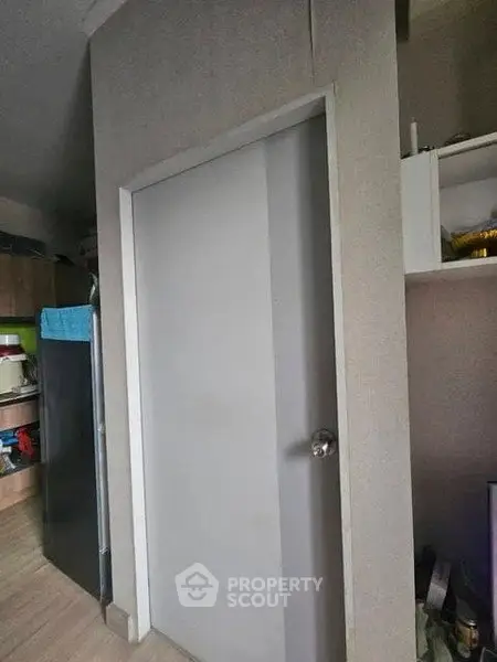 Modern interior with sleek door and organized kitchen storage