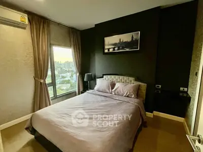 Modern bedroom with city view, featuring elegant decor and large window for natural light.