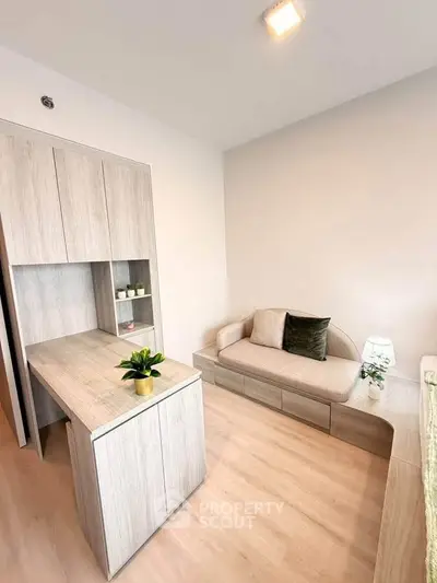 Modern minimalist living room with light wood furniture and cozy sofa