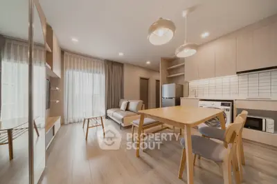 Modern open-plan living room with stylish kitchen and cozy seating area