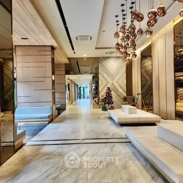 Luxurious modern building entrance with elegant lighting and seating area.