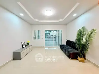 Spacious modern living room with sleek design and large windows for natural light.