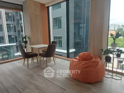 Modern apartment interior with large windows and stylish furniture