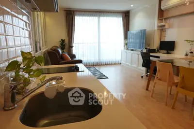 Spacious modern living room with open kitchen and natural light